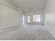 Spacious living room with vaulted ceiling, neutral carpet and an abundance of natural light at 21550 Clubside Loop, Lutz, FL 33549
