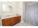 Well-lit bathroom, granite countertop, shower, and patterned curtain at 2633 Edgewater Falls Dr, Brandon, FL 33511
