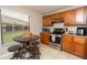 Kitchen with wood cabinets, stainless steel appliances and breakfast table at 2633 Edgewater Falls Dr, Brandon, FL 33511