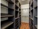 Large walk-in closet with ample shelving and rods at 2749 Via Cipriani # 1032A, Clearwater, FL 33764