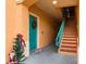 Inviting entryway with teal door and festive decor at 2749 Via Cipriani # 1032A, Clearwater, FL 33764