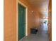 Shared hallway with teal doors and outdoor access at 2749 Via Cipriani # 1032A, Clearwater, FL 33764