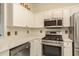 Modern kitchen with white cabinets and stainless steel appliances at 2749 Via Cipriani # 1032A, Clearwater, FL 33764