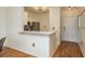 White kitchen with stainless steel appliances and breakfast bar at 2749 Via Cipriani # 1032A, Clearwater, FL 33764
