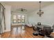 Bright living room featuring hardwood floors and a modern chandelier at 2749 Via Cipriani # 1032A, Clearwater, FL 33764