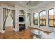 Living room with fireplace, hardwood floors, and large windows at 2749 Via Cipriani # 1032A, Clearwater, FL 33764