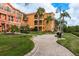 Brick-paved walkway winds through lush landscaping at 2749 Via Cipriani # 1032A, Clearwater, FL 33764