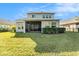 Private backyard featuring a screened-in porch and lush green lawn at 3121 Satilla Loop, Odessa, FL 33556