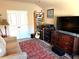 Cozy bedroom with a couch, bookcase, TV, and decorative rug at 3121 Satilla Loop, Odessa, FL 33556