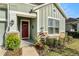 House entrance with red door and stone accents at 3121 Satilla Loop, Odessa, FL 33556