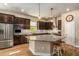 Kitchen featuring stainless steel appliances, modern backsplash, and a kitchen island at 3121 Satilla Loop, Odessa, FL 33556