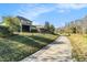 A paved pathway winds through a green landscape near homes at 3121 Satilla Loop, Odessa, FL 33556