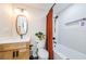 Modern bathroom with updated vanity, fixtures, and stylish orange shower curtain at 3311 San Mateo St, Clearwater, FL 33759