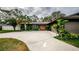 Mid-century modern home with circular driveway and lush landscaping at 3311 San Mateo St, Clearwater, FL 33759