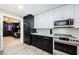 Modern kitchen with white and dark cabinets and office view at 3311 San Mateo St, Clearwater, FL 33759