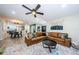 Open living space featuring a brown sectional and kitchen peek at 3311 San Mateo St, Clearwater, FL 33759