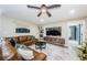 Spacious living room with brown leather sectional and large TV at 3311 San Mateo St, Clearwater, FL 33759