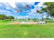 Flags and benches overlook a pond and community landscape at 5750 Apache St, Zephyrhills, FL 33542