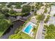 Aerial view of the property featuring a pool, lake, fountain, mature trees and community areas at 6388 93Rd N Ter # 4603, Pinellas Park, FL 33782
