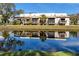 Rear exterior of townhouse reflecting in a pond with a duck swimming at 6388 93Rd N Ter # 4603, Pinellas Park, FL 33782