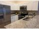 Updated kitchen with stainless steel appliances, granite countertops, and white cabinetry at 6388 93Rd N Ter # 4603, Pinellas Park, FL 33782
