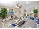 Spacious living room featuring a sectional sofa, gray flooring, and an entertainment center at 6388 93Rd N Ter # 4603, Pinellas Park, FL 33782