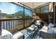 Relaxing screened-in patio featuring water view, stylish furniture, and a decorative blue rug at 6388 93Rd N Ter # 4603, Pinellas Park, FL 33782