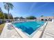 Sparkling community pool with clear blue water, surrounded by a white fence and lounge chairs on a sunny day at 6388 93Rd N Ter # 4603, Pinellas Park, FL 33782