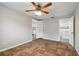 Bedroom with tile floors, ceiling fan, and laundry access at 6403 Butte Ave, New Port Richey, FL 34653