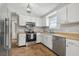 Updated kitchen featuring stainless steel appliances and tiled floors at 6403 Butte Ave, New Port Richey, FL 34653