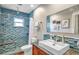 Modern bathroom with a blue tile shower and updated vanity at 7266 Orkney N Ave, St Petersburg, FL 33709