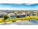 Aerial view showcasing a community of homes near a lake at 7506 Parkshore Dr, Apollo Beach, FL 33572