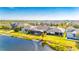 Aerial view of a house with a pool, near a lake at 7506 Parkshore Dr, Apollo Beach, FL 33572
