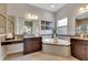 Bathroom with double vanity, large soaking tub, and walk-in shower at 7506 Parkshore Dr, Apollo Beach, FL 33572