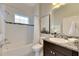 Clean bathroom with granite vanity, shower/tub combo, and white tile at 7506 Parkshore Dr, Apollo Beach, FL 33572