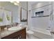 Clean bathroom with granite vanity and shower/tub combo at 7506 Parkshore Dr, Apollo Beach, FL 33572