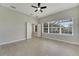 Spacious bedroom with tile flooring, ceiling fan, and access to backyard at 7506 Parkshore Dr, Apollo Beach, FL 33572