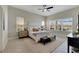 Spacious bedroom with a king-size bed, large windows, and ample natural light at 7506 Parkshore Dr, Apollo Beach, FL 33572