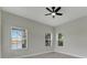 Bright bedroom with ceiling fan and multiple windows at 7506 Parkshore Dr, Apollo Beach, FL 33572