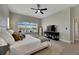 Main bedroom with king bed, large windows, and access to the backyard at 7506 Parkshore Dr, Apollo Beach, FL 33572