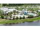 Aerial view of resort-style pool with water slide and clubhouse at 7506 Parkshore Dr, Apollo Beach, FL 33572