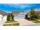 Two-story home with gray exterior, three-car garage, and landscaped yard at 7506 Parkshore Dr, Apollo Beach, FL 33572