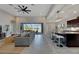 Open kitchen boasts granite countertops, dark cabinetry, and an island with seating at 7506 Parkshore Dr, Apollo Beach, FL 33572