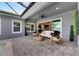 Relaxing covered patio with seating area, overlooking the pool at 7506 Parkshore Dr, Apollo Beach, FL 33572
