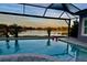 Stunning pool and patio area with lake view at 7506 Parkshore Dr, Apollo Beach, FL 33572