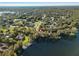 Stunning aerial view of a waterfront property surrounded by lush greenery, showcasing its prime location and natural beauty at 905 Lake Fuller Dr, Lutz, FL 33548