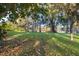 Landscaped backyard with lake access and mature trees at 905 Lake Fuller Dr, Lutz, FL 33548