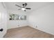 Bright bedroom with large window, ceiling fan and wood-look floors at 905 Lake Fuller Dr, Lutz, FL 33548