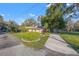 Well-maintained house with manicured lawn, a circular driveway, and lush landscaping, showcasing its curb appeal at 905 Lake Fuller Dr, Lutz, FL 33548