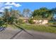 Quaint single-story home with mature landscaping and a well-maintained front lawn at 905 Lake Fuller Dr, Lutz, FL 33548